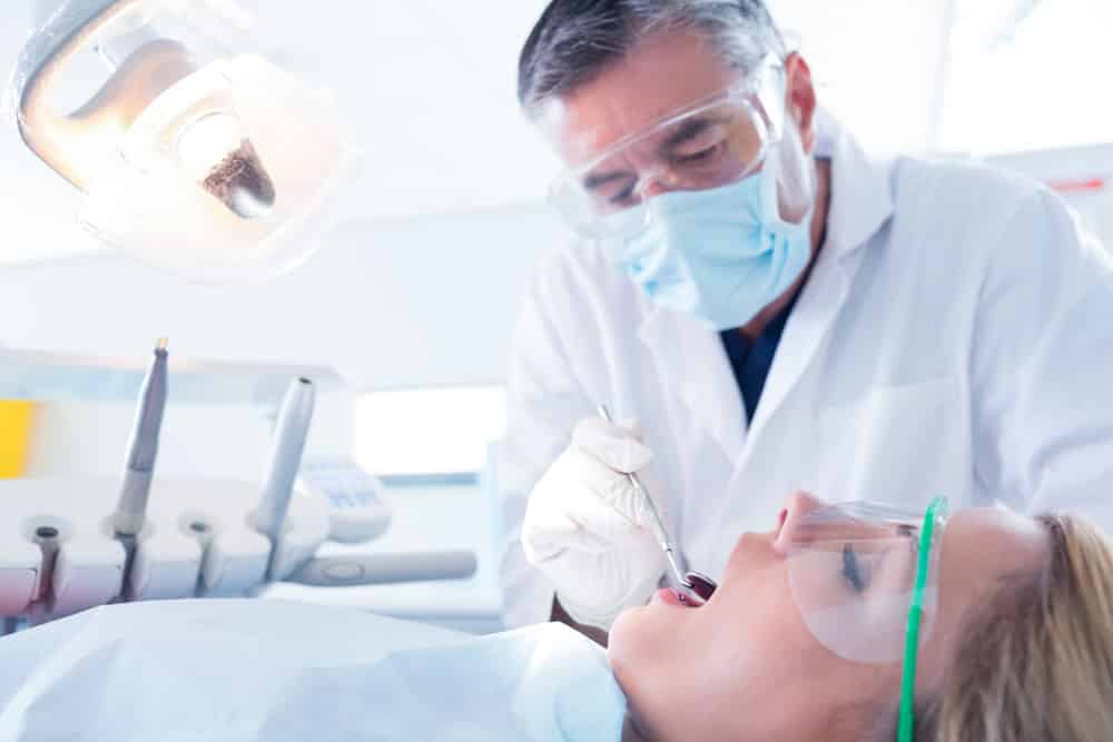 Dentist Examining Patients Teeth — Dental in Cardiff, NSW