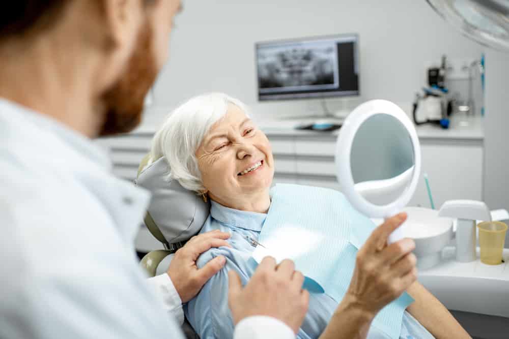 Patient Inspecting Dental Fillings in Mirror