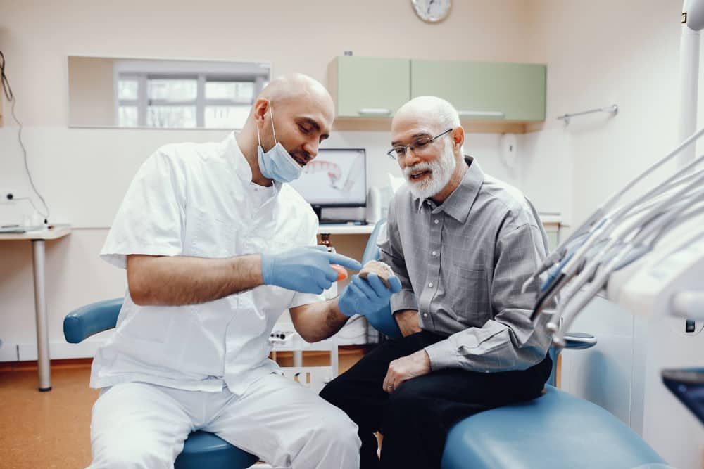 Elderly Man Talking To The Dentist